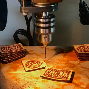 Image of Rare Minded Productions engraved leather patches on drill press